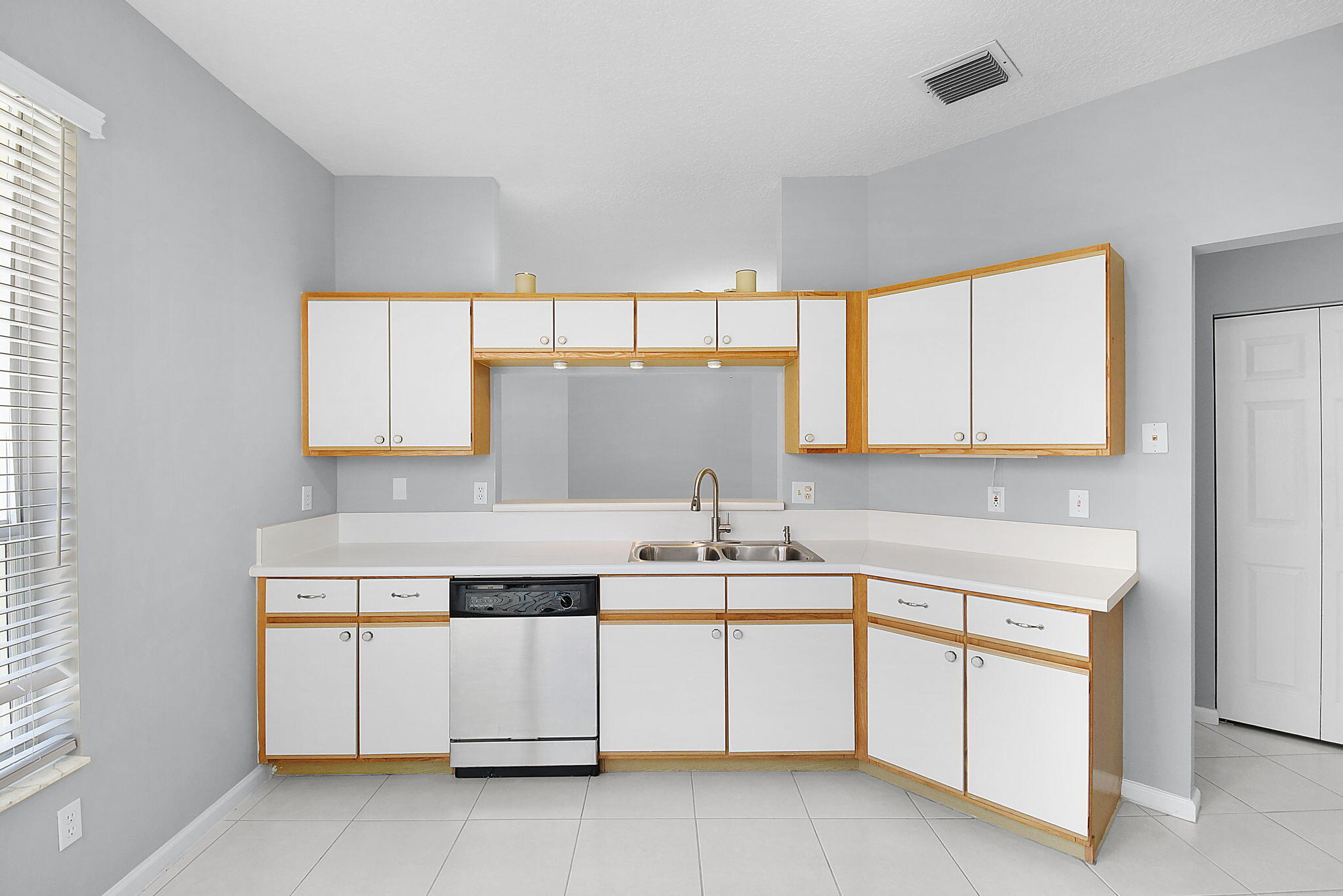 6785 Southeast Warwick Lane Stuart, FL 34997 - Photo 13 of 62 a kitchen with a sink stove and cabinets