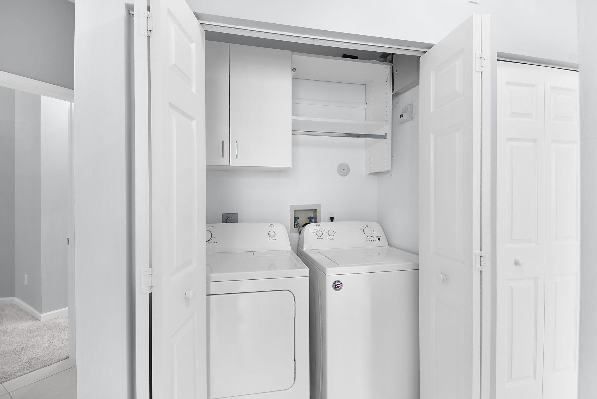 6785 Southeast Warwick Lane Stuart, FL 34997 - Photo 18 of 62 a utility room with dryer and washer