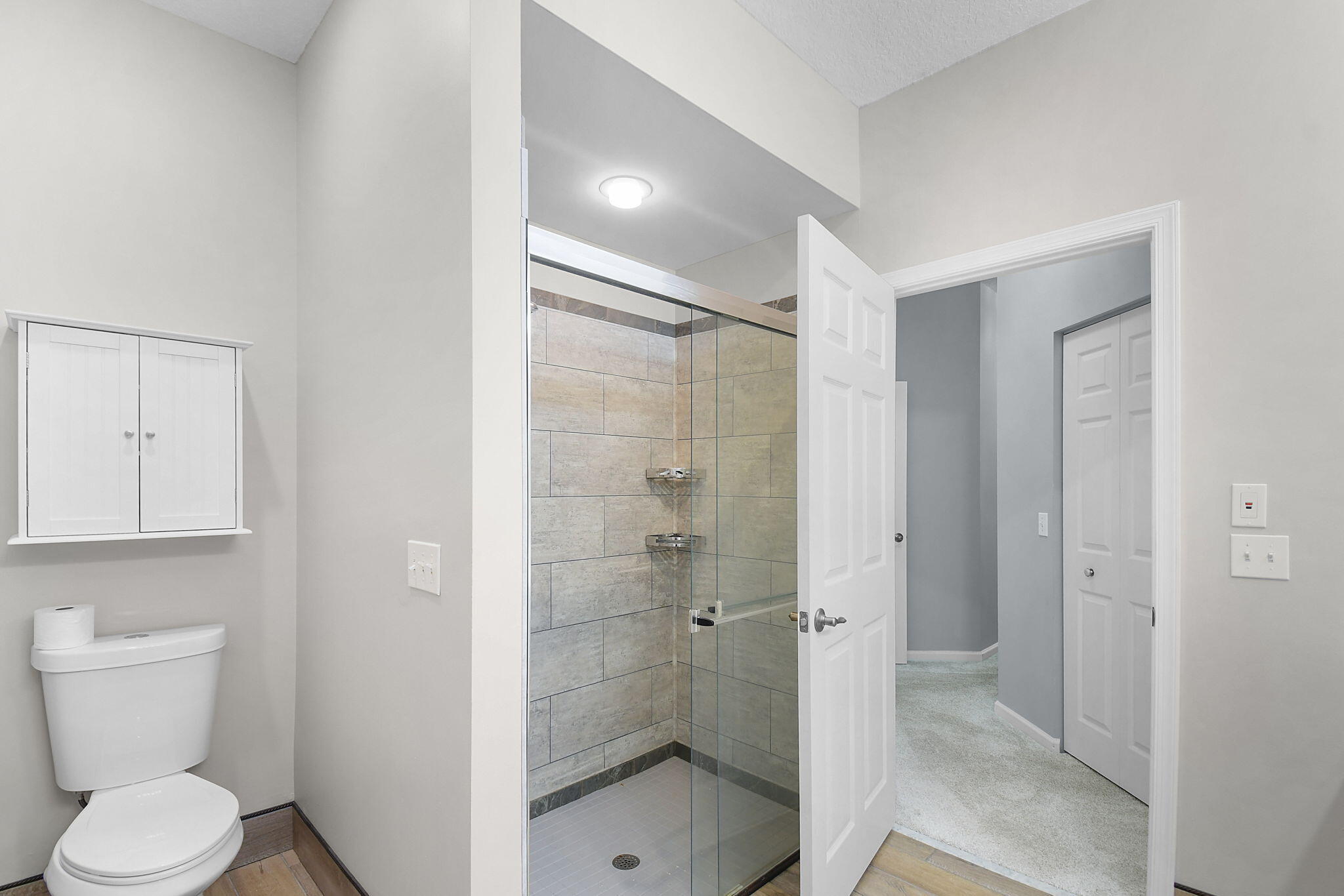 6785 Southeast Warwick Lane Stuart, FL 34997 - Photo 23 of 62 a bathroom with a shower and toilet