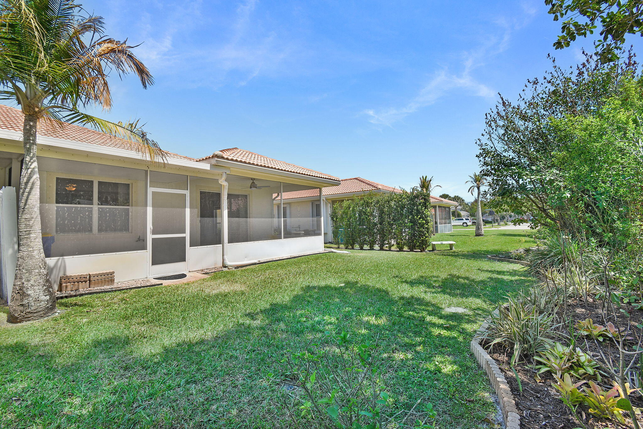 6785 Southeast Warwick Lane Stuart, FL 34997 - Photo 30 of 62 a view of a house with a yard