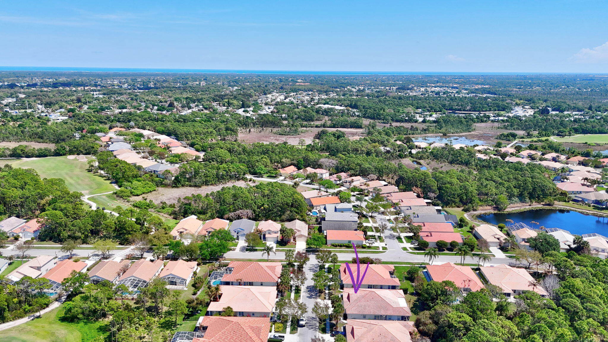 6785 Southeast Warwick Lane Stuart, FL 34997 - Photo 40 of 62 an aerial view of a city with lots of residential buildings ocean and mountain view in back