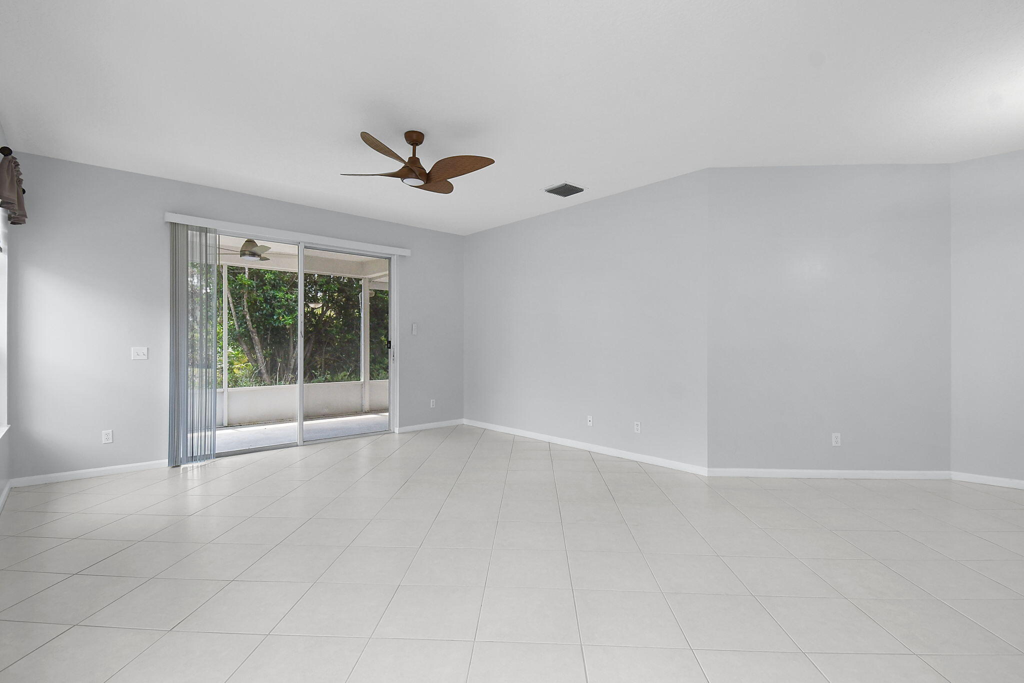 6785 Southeast Warwick Lane Stuart, FL 34997 - Photo 4 of 62 a view of an empty room with a window