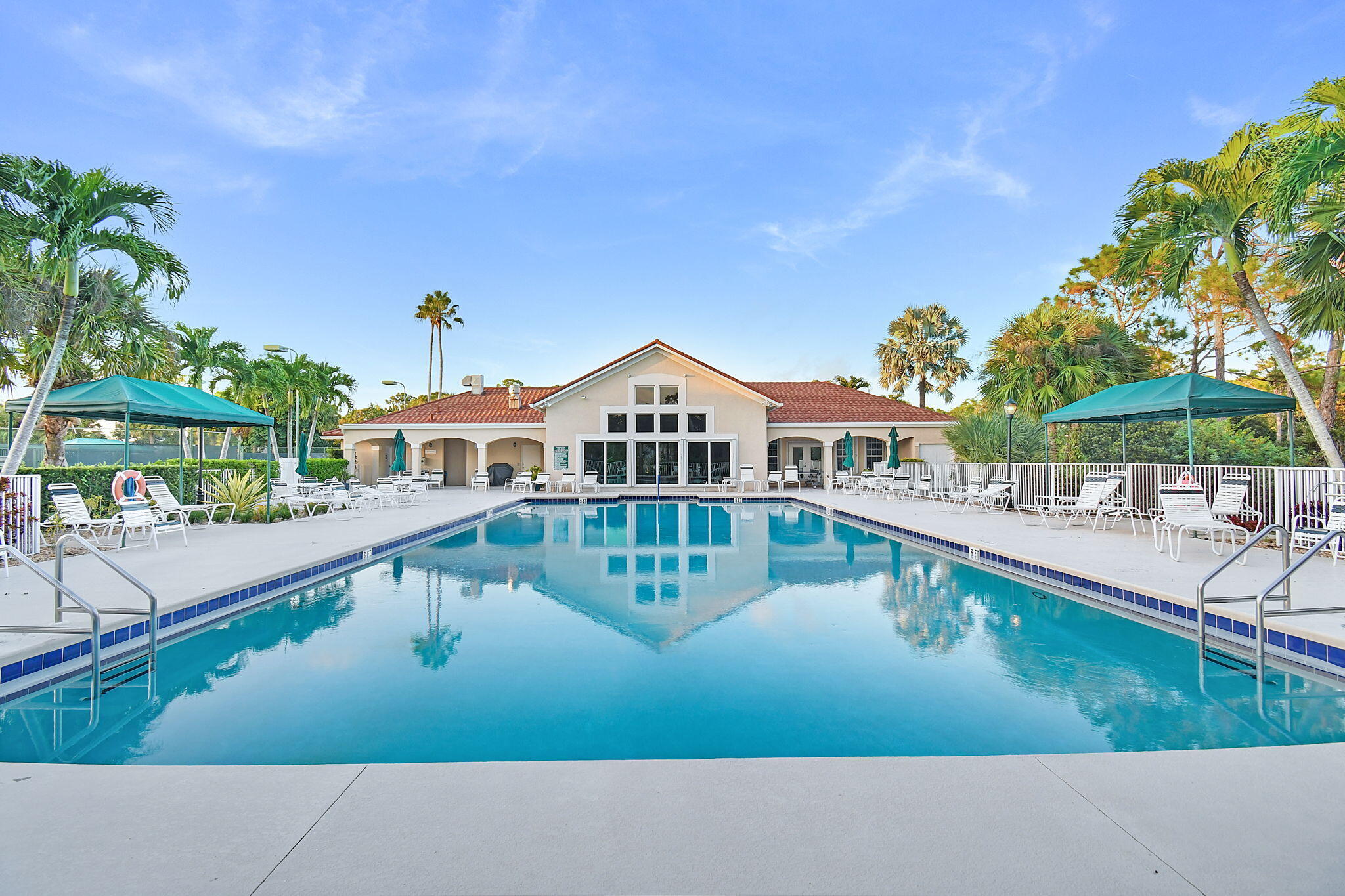 6785 Southeast Warwick Lane Stuart, FL 34997 - Photo 53 of 62 a view of a house with pool and chairs