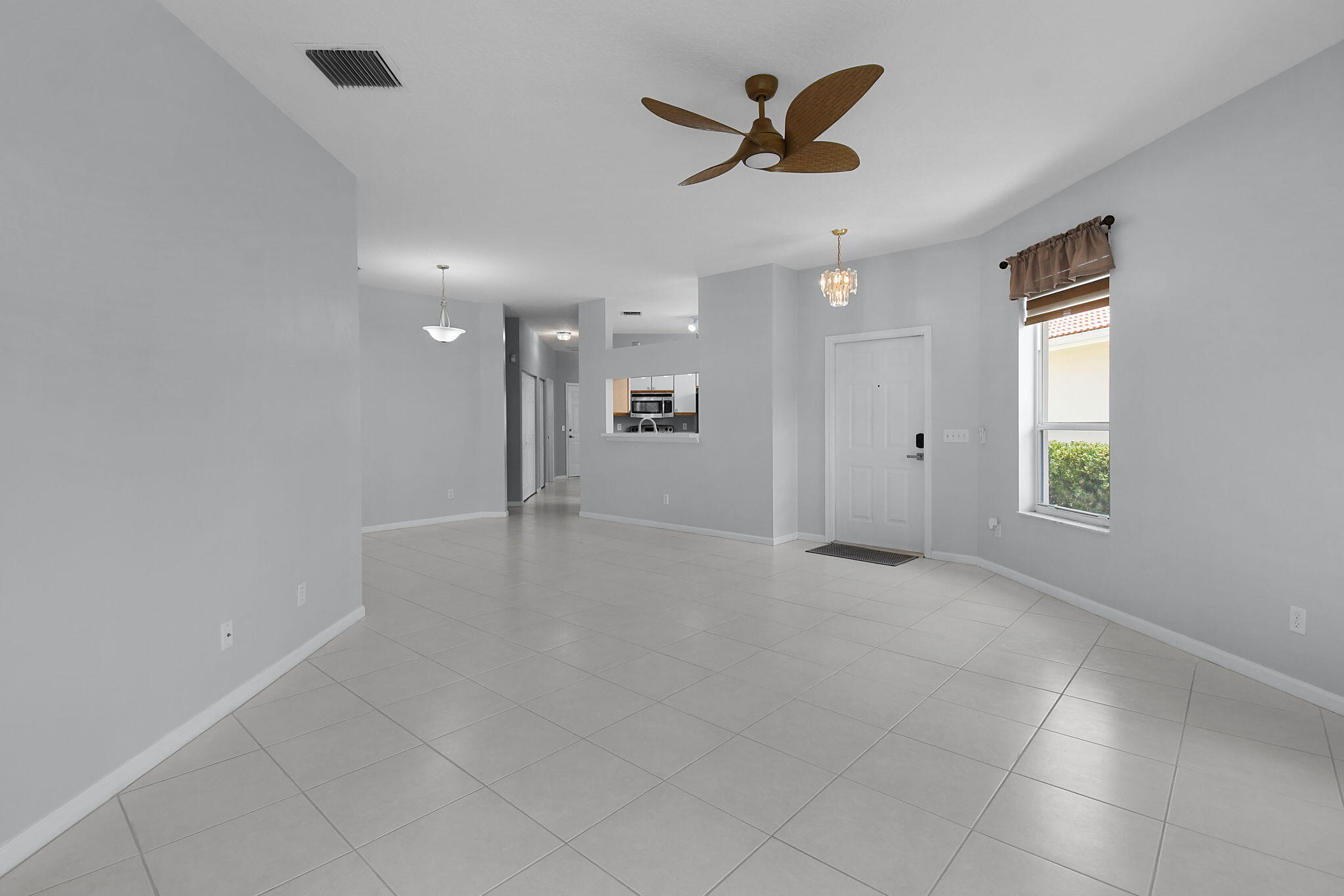 6785 Southeast Warwick Lane Stuart, FL 34997 - Photo 8 of 62 a view of a livingroom with a ceiling fan and window