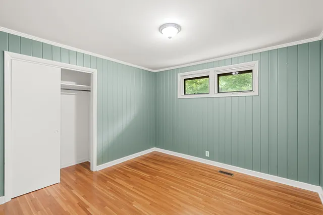 a view of a room with wooden floor and closet