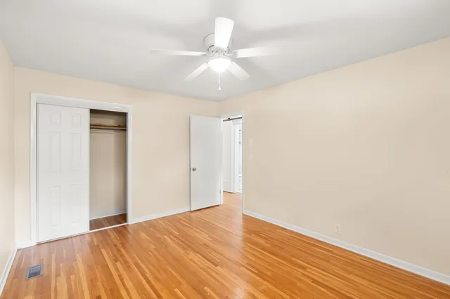 a view of an empty room with wooden floor