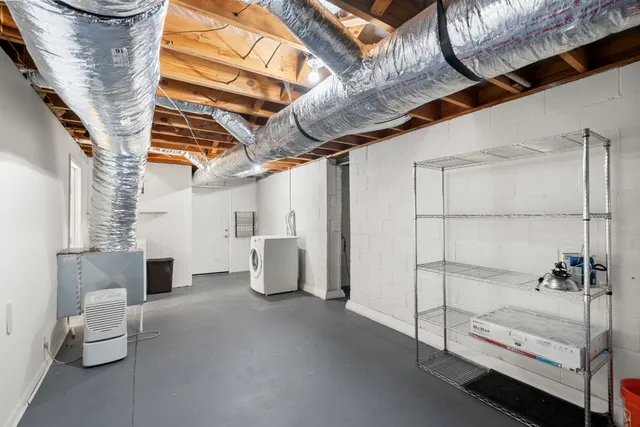 a spacious bedroom with a bed and a chandelier