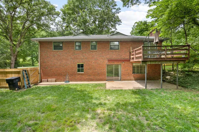 a view of a house with a yard and sitting area