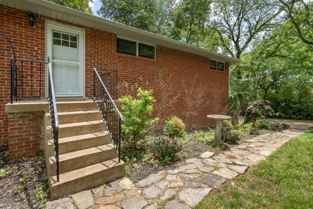 a view of a pathway of a house with backyard and garden