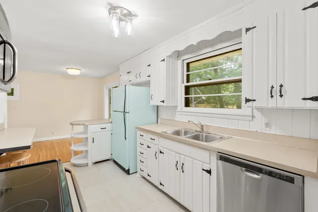 a kitchen with a sink and a refrigerator
