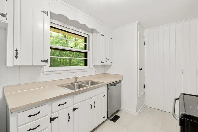 a kitchen with a sink and a window