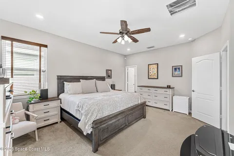 a spacious bedroom with a bed and a couch