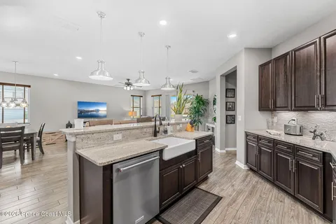 a kitchen with stainless steel appliances granite countertop a sink stove and cabinets