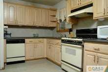 16 Finley Road Edison, NJ 08817 - Photo 5 of 6 a kitchen with granite countertop white cabinets and white appliances