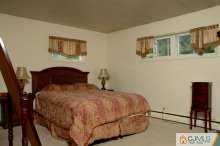 16 Finley Road Edison, NJ 08817 - Photo 6 of 6 a bedroom with a bed and painting on the wall