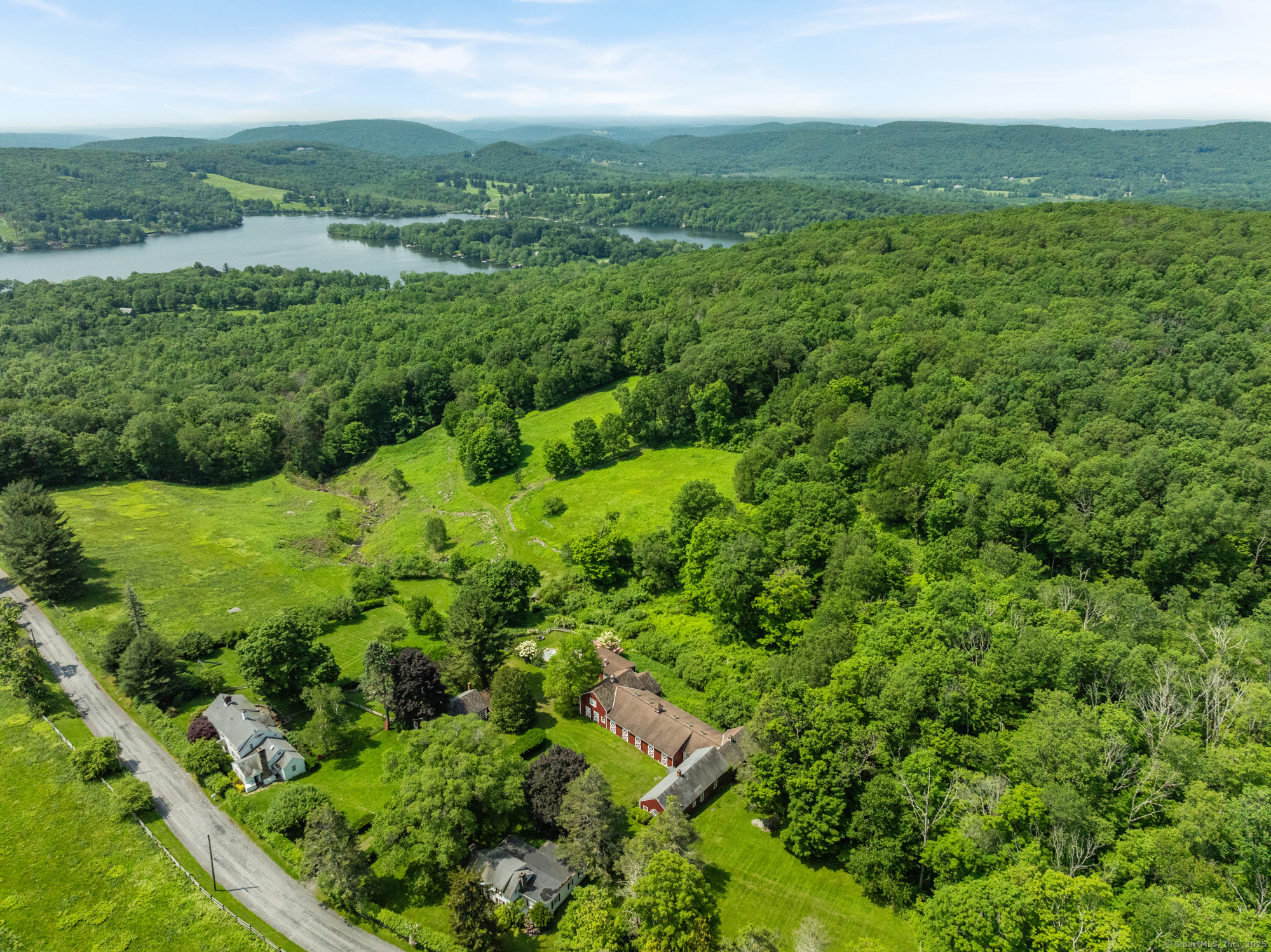 132 Curtiss Road Warren, CT 06777 - Photo 4 of 21 a view of a lush green forest with trees and grass