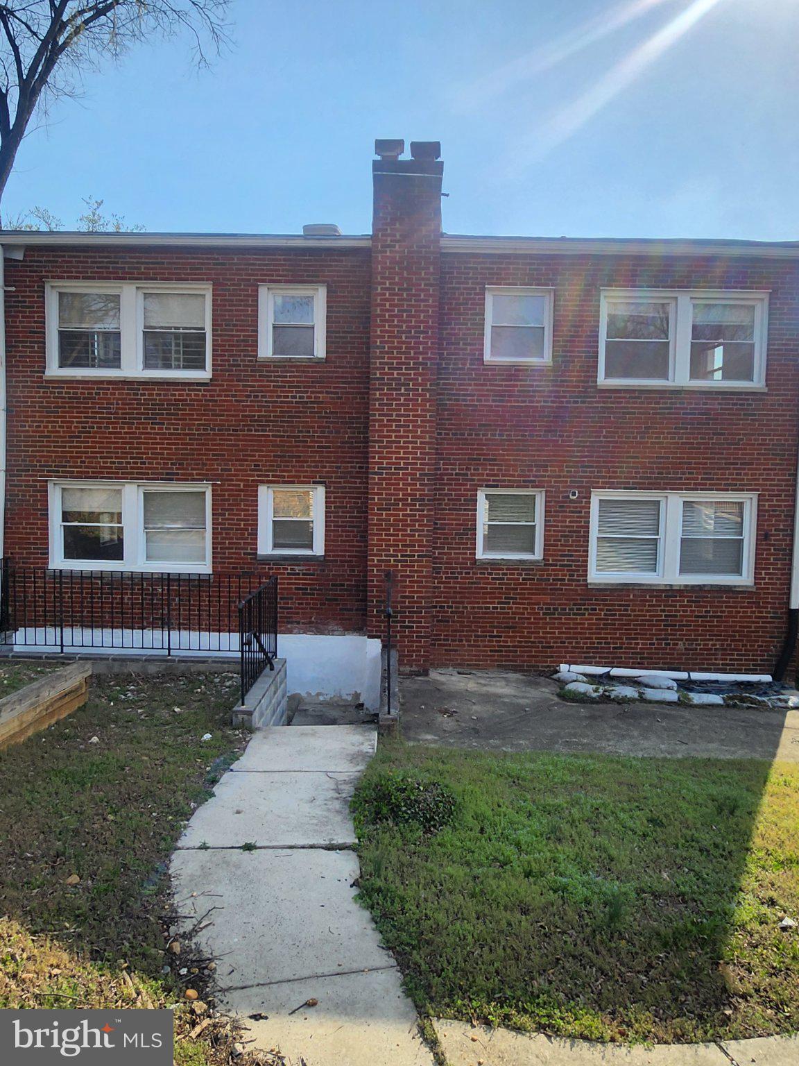 3837 1st Street Southeast Washington, DC 20032 - Photo 2 of 2 a front view of a house with garden