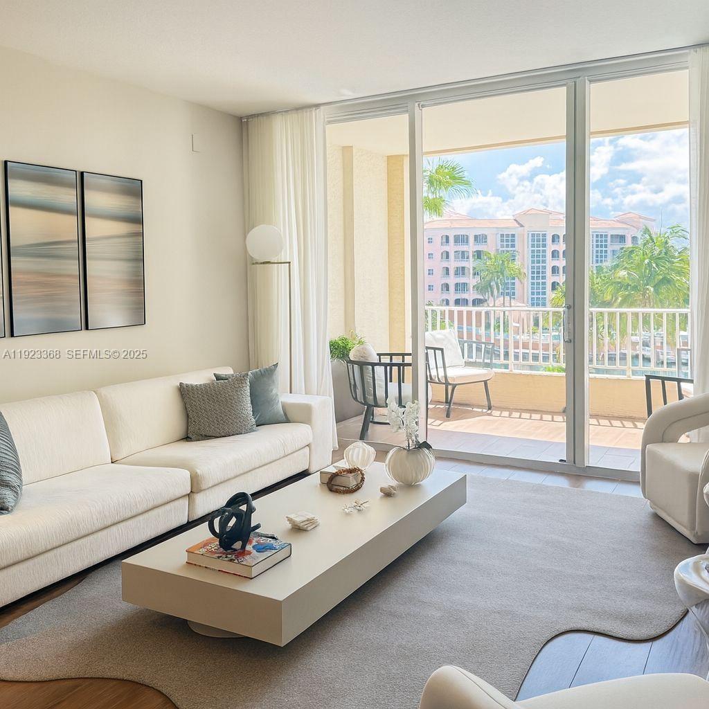 711 Crandon Boulevard, Unit 401 Key Biscayne, FL 33149 - Photo 1 of 33 a living room with furniture and a large window with balcony view
