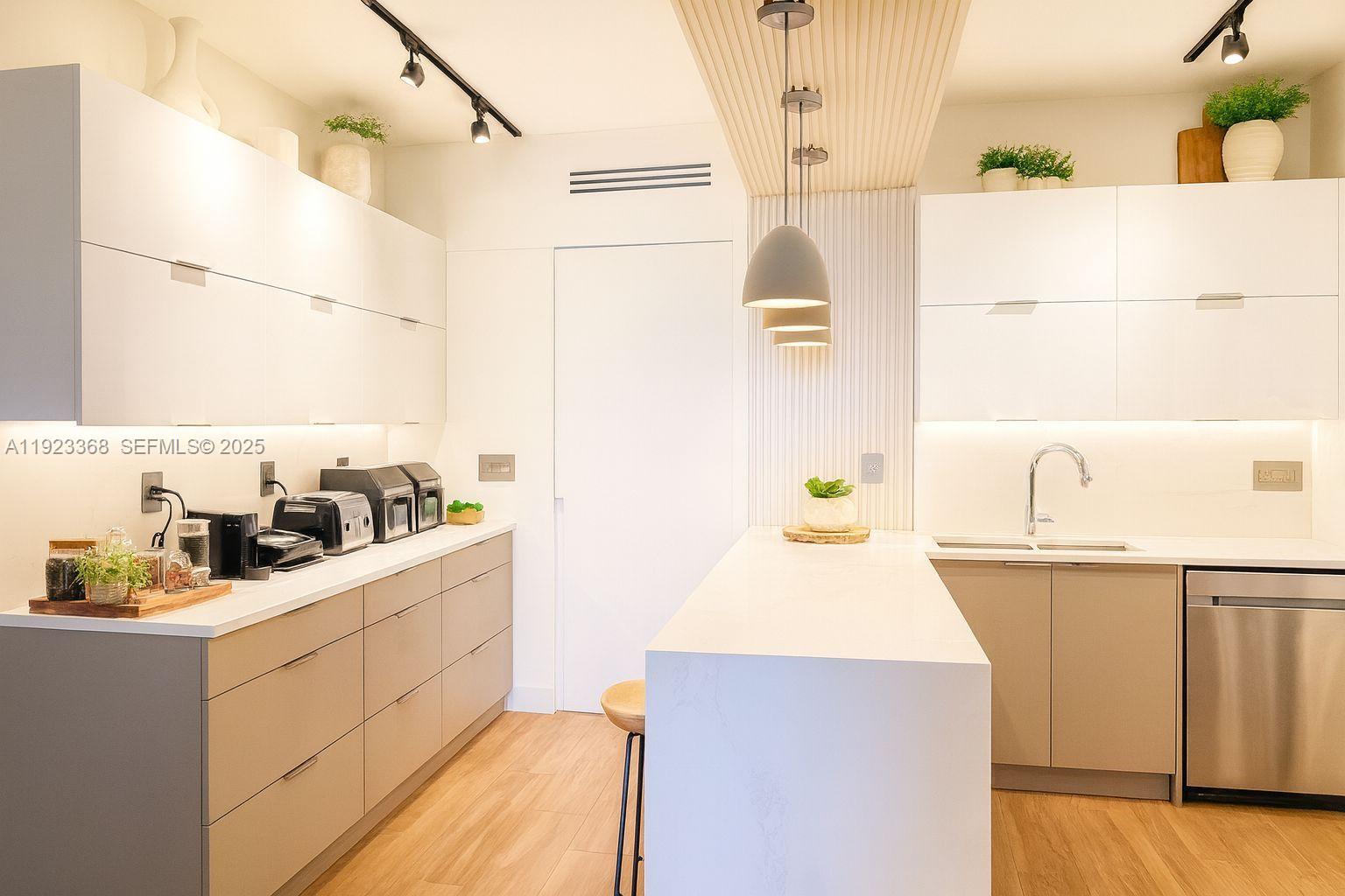 711 Crandon Boulevard, Unit 401 Key Biscayne, FL 33149 - Photo 4 of 33 a kitchen with a sink a stove and cabinets