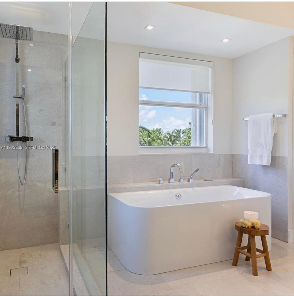 711 Crandon Boulevard, Unit 401 Key Biscayne, FL 33149 - Photo 7 of 33 a bathroom with a bathtub and a sink