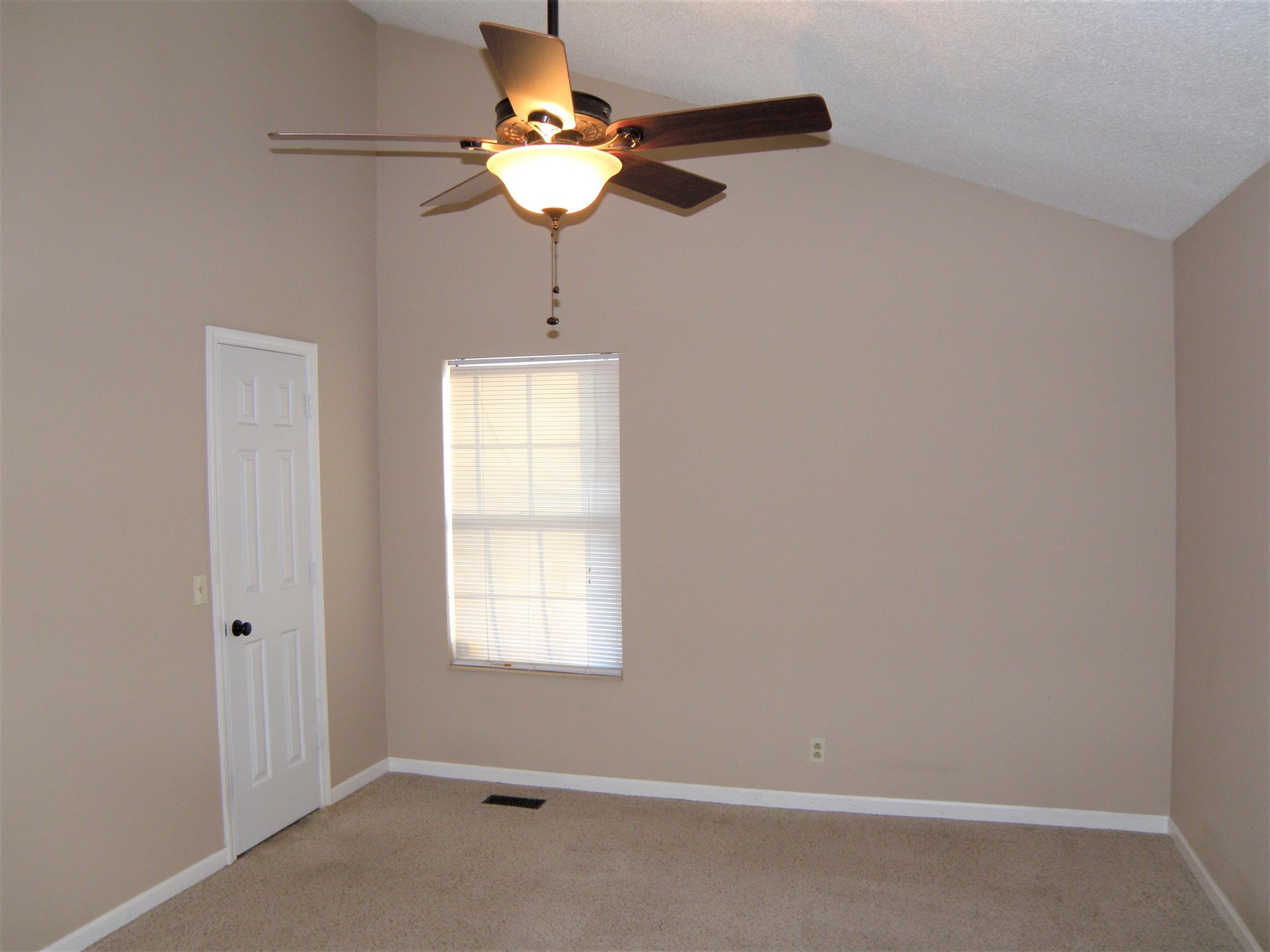 3517 Country Way Road Antioch, TN 37013 - Photo 9 of 15 an empty room with a chandelier fan and windows