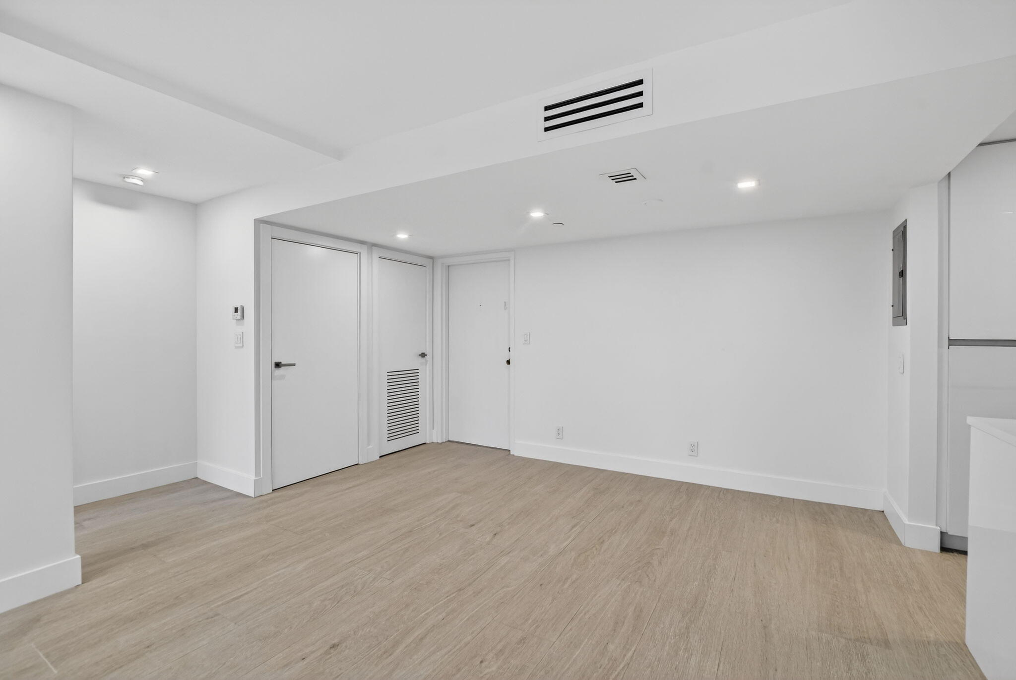 7835 Lakeside Boulevard, Unit 946 Boca Raton, FL 33434 - Photo 7 of 20 an empty room with wooden floor and windows
