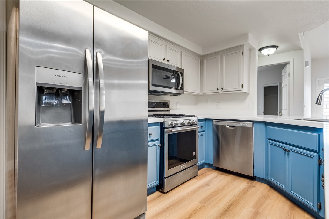 10550 West Alexander Road, Unit 2174 Las Vegas, NV 89129 - Photo 9 of 28 Warm wood flooring complements the dual-tone cabinetry and modern stainless steel finishes.