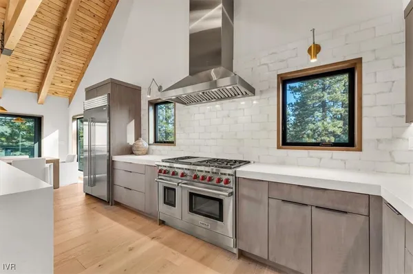 a kitchen with stainless steel appliances a stove a sink and a refrigerator