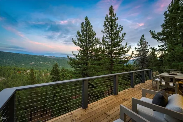 a view of roof deck with couches and wooden floor
