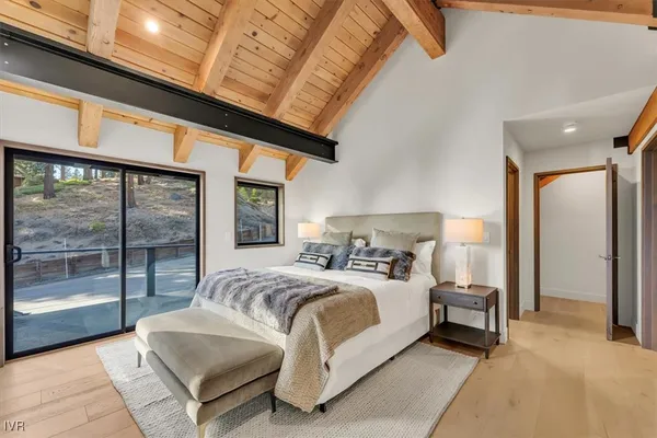 a bedroom with a large bed and a large window