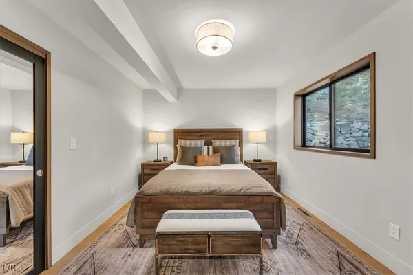 a bedroom with a bed and a painting on the wall