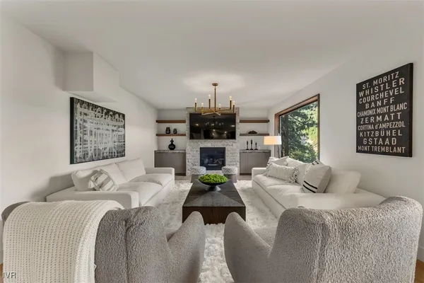 a bedroom with a bed a couch and a chandelier