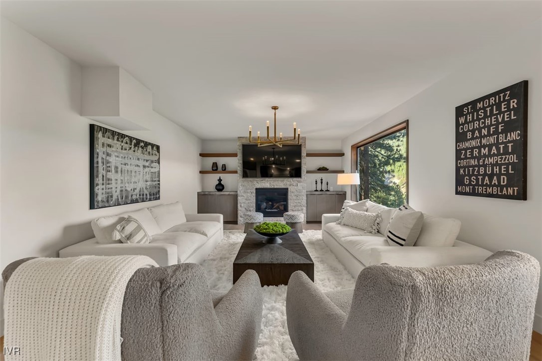 877 Tyner Way Incline Village, NV 89451 - Photo 30 of 43 a bedroom with a bed a couch and a chandelier