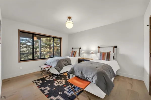 a bedroom with two beds and a window