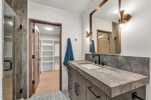 a bathroom with a sink vanity and a mirror