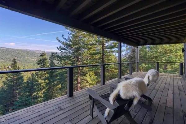 a view of balcony with wooden floor and outdoor seating