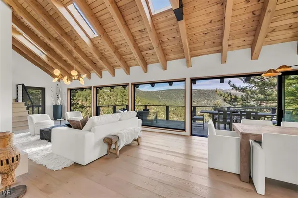 a living room with furniture and large windows