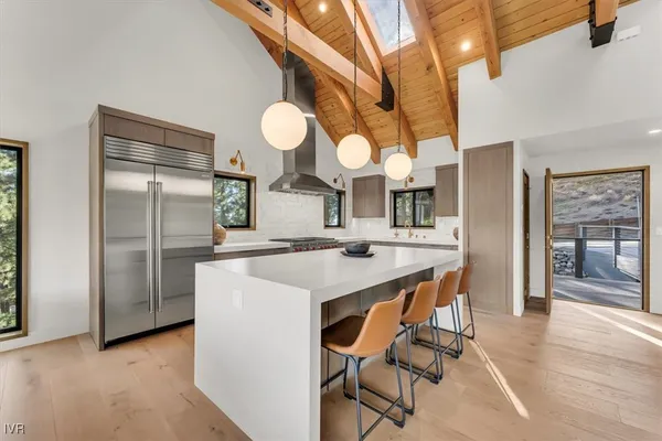 a kitchen with stainless steel appliances granite countertop a sink a stove and a refrigerator