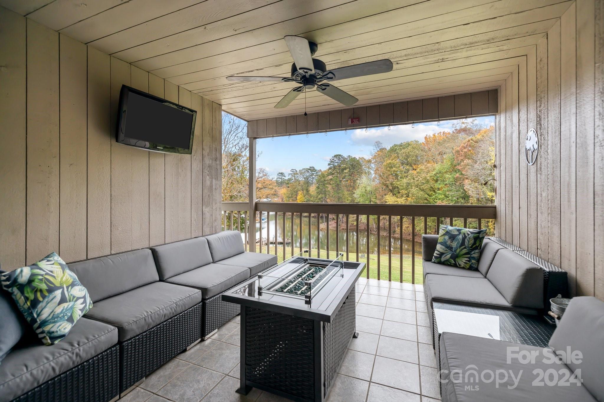 55 Ridgeport Road Lake Wylie, SC 29710 - Photo 8 of 45 a living room with furniture tv and a floor to ceiling window