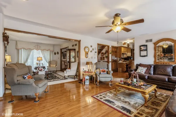 a living room with furniture and wooden floor