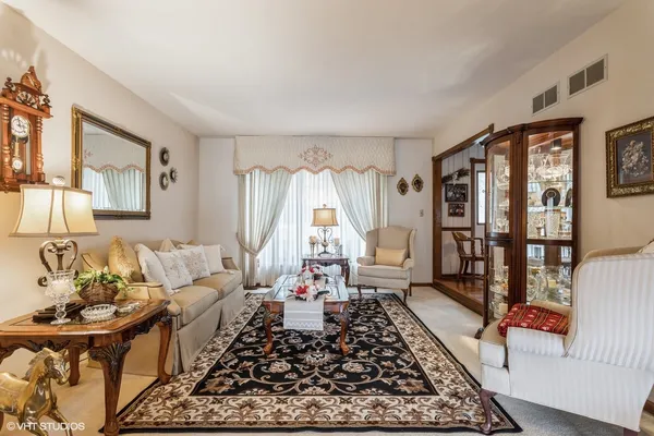 a living room with furniture and a rug