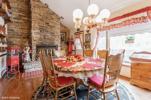 a view of a dining room with furniture and chandelier