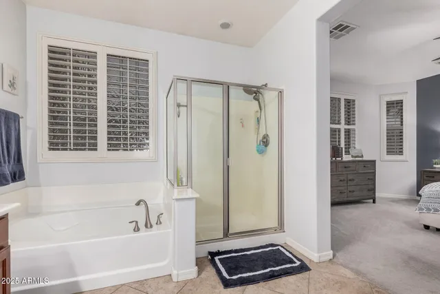 a bathroom with a bathtub and a shower