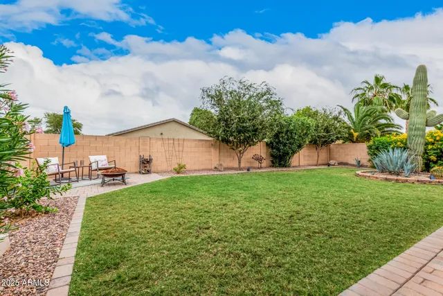a house view with swimming pool and garden space