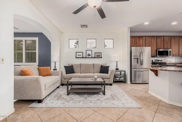 a living room with furniture and kitchen view