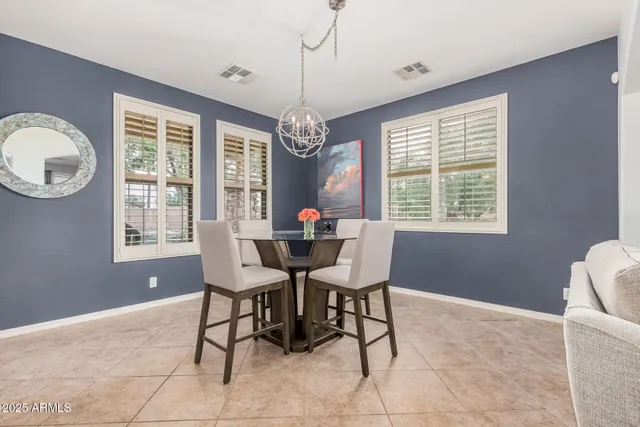 a dining room with furniture a chandelier and window