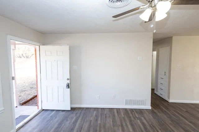 a view of a room with wooden floor and closet