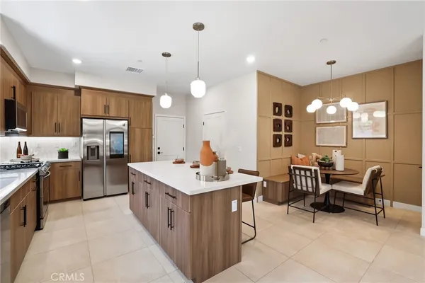 a kitchen that has a lot of cabinets in it and wooden floors
