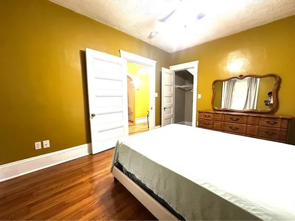 a bedroom with a bed and a flat screen tv