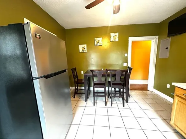 a view of a dining room with furniture and a potted plant